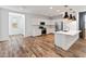 Bright, spacious kitchen features white cabinets, stainless steel appliances, and wood-look floors at 3264 W Caleb Rd, Phoenix, AZ 85083
