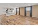Spacious living area with wood-look floors and bright kitchen in background at 3264 W Caleb Rd, Phoenix, AZ 85083