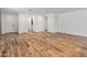 Large, open-concept living area with hardwood floors, and white walls at 3264 W Caleb Rd, Phoenix, AZ 85083