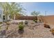 Low maintenance backyard featuring decorative rock, desert landscaping and shrubbery at 3268 W Caleb Rd, Phoenix, AZ 85083
