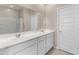 Bathroom features double sink vanity with white cabinets, large mirror, and tiled floors at 3268 W Caleb Rd, Phoenix, AZ 85083