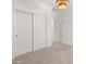 Bright bedroom features carpeted floors and a modern chandelier at 3268 W Caleb Rd, Phoenix, AZ 85083