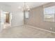 Bright bedroom with neutral carpet, two windows with blinds, and ensuite bathroom at 3268 W Caleb Rd, Phoenix, AZ 85083