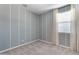 Bedroom with light gray walls, white painted stripes, and a window with white curtains at 3268 W Caleb Rd, Phoenix, AZ 85083