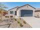 Attractive single-Gathering home featuring a desert landscape and blue two car garage door at 3268 W Caleb Rd, Phoenix, AZ 85083
