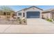 Charming single-story home with a well-maintained front yard and blue two car garage door at 3268 W Caleb Rd, Phoenix, AZ 85083