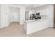 Kitchen features white cabinets and open view to living space at 3268 W Caleb Rd, Phoenix, AZ 85083
