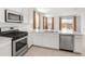 Open kitchen with stainless steel appliances, white cabinets, and views of the backyard at 3268 W Caleb Rd, Phoenix, AZ 85083