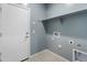 Functional laundry room with overhead shelving and washer-dryer hookups at 3268 W Caleb Rd, Phoenix, AZ 85083