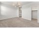 Open floor plan view of the living room with a contemporary light fixture at 3268 W Caleb Rd, Phoenix, AZ 85083