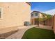 This backyard features low maintenance landscape, artificial grass, and air conditioning unit at 3443 E Jasper Dr, Gilbert, AZ 85296