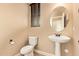Powder bathroom featuring a pedestal sink, oval mirror, and natural light from the window at 3443 E Jasper Dr, Gilbert, AZ 85296