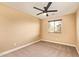 Bright carpeted bedroom featuring a ceiling fan and window letting in natural light at 3443 E Jasper Dr, Gilbert, AZ 85296