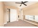 This bedroom features neutral walls, carpet flooring, closet with white doors and a ceiling fan at 3443 E Jasper Dr, Gilbert, AZ 85296
