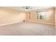 Bright, neutral bedroom space with carpeted floor, ceiling fan, and multiple windows at 3443 E Jasper Dr, Gilbert, AZ 85296