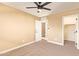 Bedroom featuring neutral walls, carpet flooring, closet and ceiling fan at 3443 E Jasper Dr, Gilbert, AZ 85296