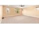 Spacious bedroom with neutral walls and carpet, featuring multiple windows for natural light at 3443 E Jasper Dr, Gilbert, AZ 85296