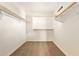 Walk-in closet with carpeted floor, wooden racks, and open space for storage at 3443 E Jasper Dr, Gilbert, AZ 85296