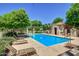Community pool area with lounge chairs, perfect for relaxing and socializing at 3443 E Jasper Dr, Gilbert, AZ 85296