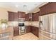 Well-equipped kitchen with stainless steel appliances and wooden cabinetry offers style and functionality at 3443 E Jasper Dr, Gilbert, AZ 85296