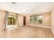 Bright living area showcasing hardwood floors and sliding glass doors to the patio at 3443 E Jasper Dr, Gilbert, AZ 85296