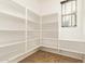 Walk-in pantry with ample shelving provides organized storage space and natural light at 3443 E Jasper Dr, Gilbert, AZ 85296