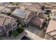 Aerial view of a well-maintained home with a two-car garage and solar panels, nestled in a tidy neighborhood at 3488 S Bowman Rd, Apache Junction, AZ 85119