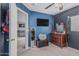 Inviting bedroom with blue walls, a modern TV, and an elegant vanity area at 3488 S Bowman Rd, Apache Junction, AZ 85119
