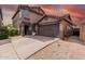 Attractive two-story home with a two-car garage, landscaping gravel and a neutral stucco exterior under a vibrant sky at 3488 S Bowman Rd, Apache Junction, AZ 85119