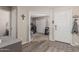 Foyer with wood-look floors, a front door, and a view into a bedroom. Features a coat closet and front door at 3488 S Bowman Rd, Apache Junction, AZ 85119