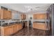 An updated kitchen with wood cabinets, black countertops and stainless steel refrigerator at 3488 S Bowman Rd, Apache Junction, AZ 85119