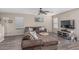 Comfortable living room with a plush sectional sofa, ceiling fan, and modern flooring. Windows let in natural light at 3488 S Bowman Rd, Apache Junction, AZ 85119
