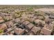 An aerial view of a neighborhood, featuring neat rows of houses, tidy streets, and a blend of desert landscaping at 3488 S Bowman Rd, Apache Junction, AZ 85119