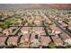 Aerial image showcasing a neighborhood with organized streets and uniform housing, complemented by a distant mountain backdrop at 3488 S Bowman Rd, Apache Junction, AZ 85119