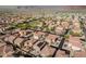 A broad aerial view of a neighborhood showcasing well-maintained homes, greenery, and the majestic mountain range as a backdrop at 3488 S Bowman Rd, Apache Junction, AZ 85119