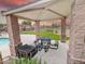 A community outdoor pavilion with a grill, picnic table, and nearby pool, perfect for relaxing and enjoying community amenities at 3488 S Bowman Rd, Apache Junction, AZ 85119