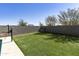 A spacious backyard featuring artificial turf and a block fence for privacy at 3914 E French Trotter St, San Tan Valley, AZ 85140