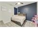 Inviting bedroom featuring a cozy bed with a decorative headboard and plush bedding at 3914 E French Trotter St, San Tan Valley, AZ 85140