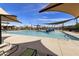 Large, inviting community pool with a splash pad, sunshades, and comfortable lounge chairs for relaxation at 3914 E French Trotter St, San Tan Valley, AZ 85140