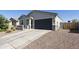 Well-maintained single-story house featuring a gray garage door and desert rock landscaping at 3914 E French Trotter St, San Tan Valley, AZ 85140
