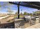 Outdoor grilling area with a built-in stainless steel grill and a pergola for shade, perfect for summer cookouts at 3914 E French Trotter St, San Tan Valley, AZ 85140