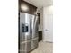 Kitchen showcasing a stainless steel refrigerator with water dispenser and dark wood cabinets at 3914 E French Trotter St, San Tan Valley, AZ 85140