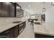 Well-equipped kitchen with granite countertops, dark cabinets, and modern stainless steel appliances at 3914 E French Trotter St, San Tan Valley, AZ 85140