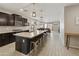 Open-concept kitchen with a large island, granite counters, and views to the living area at 3914 E French Trotter St, San Tan Valley, AZ 85140