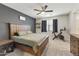 Comfortable main bedroom featuring a ceiling fan, neutral carpet, and modern decor at 3914 E French Trotter St, San Tan Valley, AZ 85140