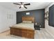 Cozy main bedroom with a ceiling fan, carpet flooring and accent wall at 3914 E French Trotter St, San Tan Valley, AZ 85140