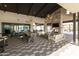 Elegant outdoor space with a fireplace, comfortable seating, a long dining table, and modern light fixtures at 3914 E French Trotter St, San Tan Valley, AZ 85140