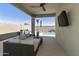 Covered patio boasts comfortable seating, a ceiling fan, and a view of the inviting backyard pool at 3914 E French Trotter St, San Tan Valley, AZ 85140