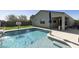 Backyard featuring pool with waterfall feature, covered patio, and basketball hoop at 3914 E French Trotter St, San Tan Valley, AZ 85140