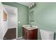 Bathroom showcasing a single vanity, a toilet and a shower with green walls at 4004 W Myrtle Ave, Phoenix, AZ 85051